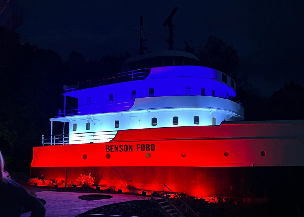 Benson Ford illuminated in the night by red and blue floodlights